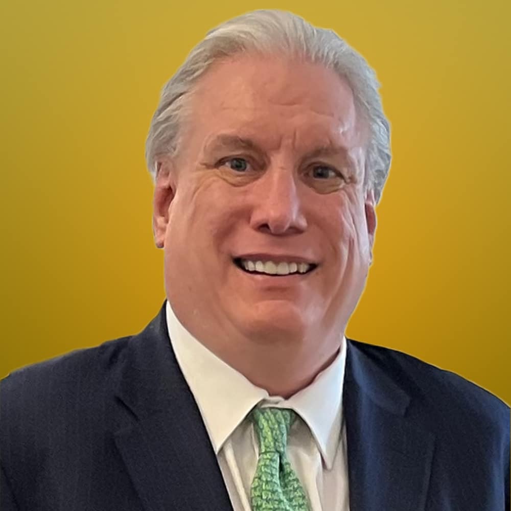 precious metals asset digitization securitization monetization hypothecation digital banking A man in a suit and tie, representing the world of FinTech, is smiling confidently in front of a vibrant yellow background.